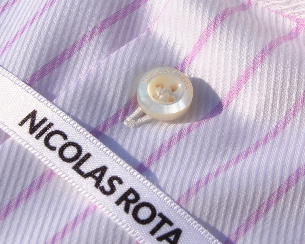 Wonderful Australian mother of pearl button with NICOLAS ROTA logo stitched into a lily.